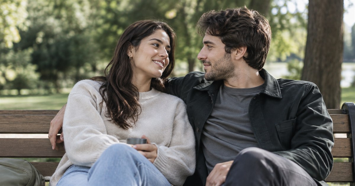 Two adults sitting together on a park bench